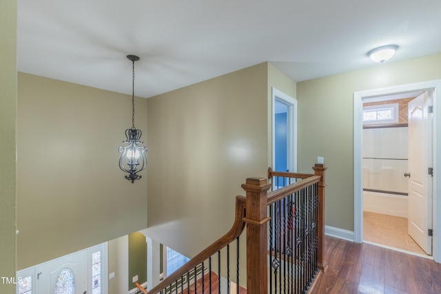 168 Melody Ln, Cameron, NC 28326 - hallway featuring an upstairs landing, dark wood-style floors, and a chandelier