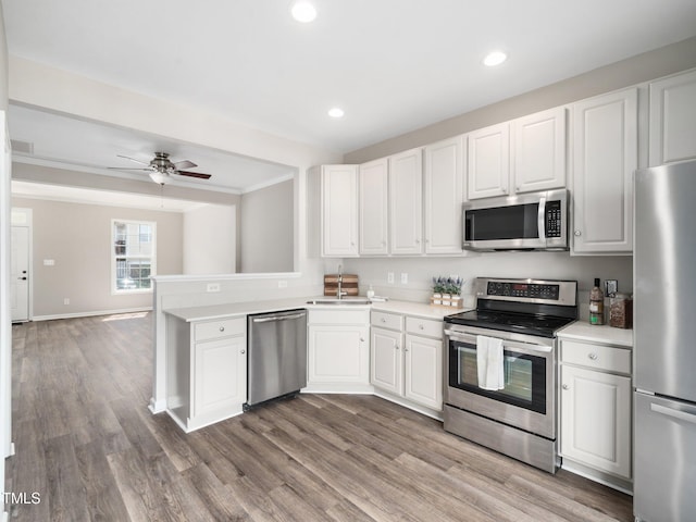 5505 Crabtree Park Ct, Raleigh, NC 27612 - kitchen featuring appliances with stainless steel finishes, light countertops, white cabinets, a ceiling fan, and recessed lighting