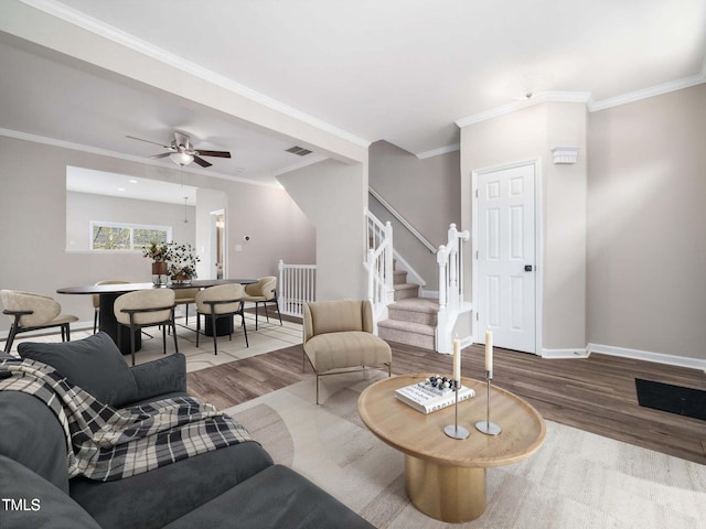 5505 Crabtree Park Ct, Raleigh, NC 27612 - living room with wood finished floors, stairs, ornamental molding, and a ceiling fan