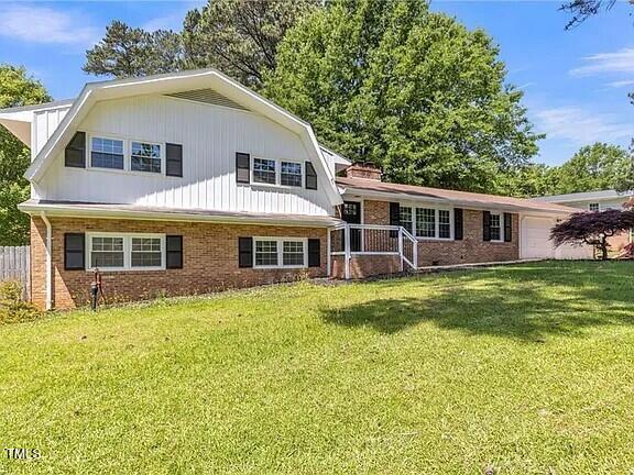 2300 Radius Cir, Sanford, NC 27330 - view of front of home featuring a front yard, an attached garage, and brick siding