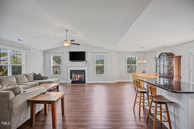 174 Arrow Ln, Middlesex, NC 27557 - living area with dark wood-style flooring, plenty of natural light, ceiling fan, lofted ceiling, and a lit fireplace