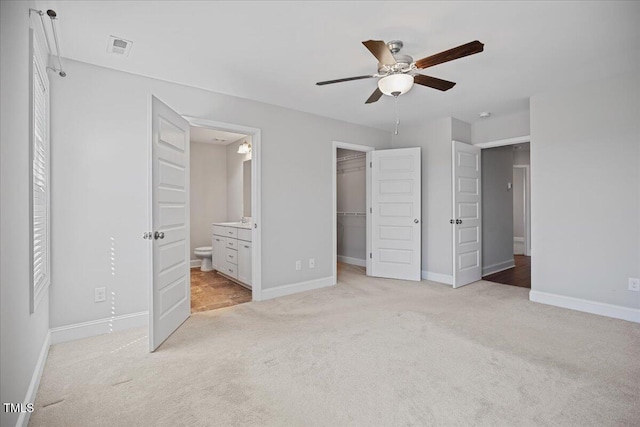 174 Arrow Ln, Middlesex, NC 27557 - unfurnished bedroom with light carpet, a spacious closet, ensuite bath, a closet, and ceiling fan