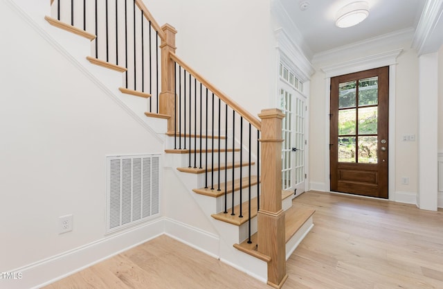 1417 Westmoreland Dr, Raleigh, NC 27612 - entryway featuring wood finished floors, ornamental molding, and stairs