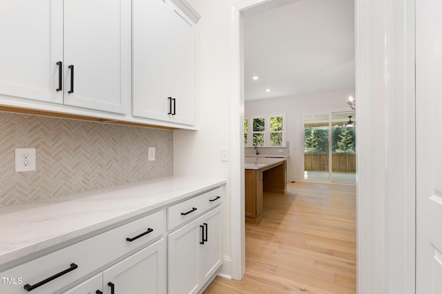 1417 Westmoreland Dr, Raleigh, NC 27612 - bar area with tasteful backsplash, light wood-style flooring, and recessed lighting