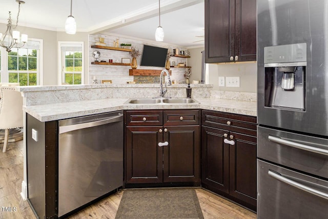3128 Bramblegate Dr, Mebane, NC 27302 - kitchen with stainless steel appliances, crown molding, dark brown cabinetry, light countertops, and decorative light fixtures