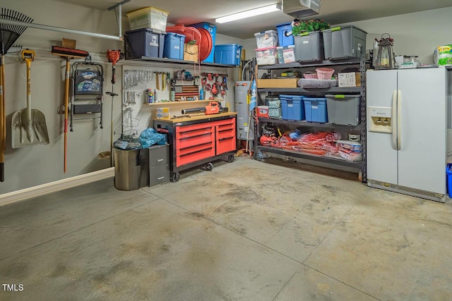 3128 Bramblegate Dr, Mebane, NC 27302 - garage featuring white refrigerator with ice dispenser, a workshop area, and a garage door opener
