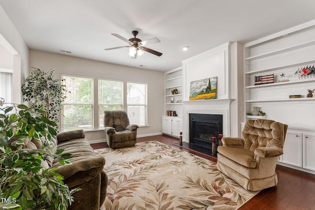 1320 Cozy Oak Ave, Cary, NC 27519 - living room with ceiling fan, dark wood finished floors, a fireplace with flush hearth, and built in features