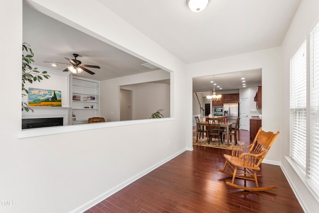1320 Cozy Oak Ave, Cary, NC 27519 - sitting room with dark wood-type flooring, a fireplace, a chandelier, and healthy amount of natural light