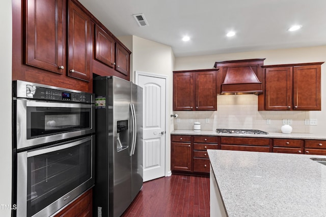 1320 Cozy Oak Ave, Cary, NC 27519 - kitchen with appliances with stainless steel finishes, custom exhaust hood, dark wood-type flooring, tasteful backsplash, and recessed lighting