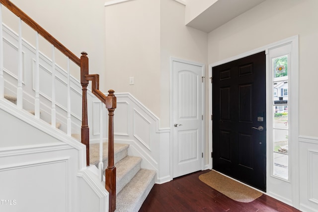 1320 Cozy Oak Ave, Cary, NC 27519 - foyer with dark wood-style flooring, stairway, a wainscoted wall, and a decorative wall