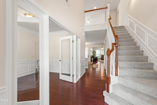 1320 Cozy Oak Ave, Cary, NC 27519 - entryway featuring hardwood / wood-style floors, a decorative wall, stairs, a wainscoted wall, and ornamental molding