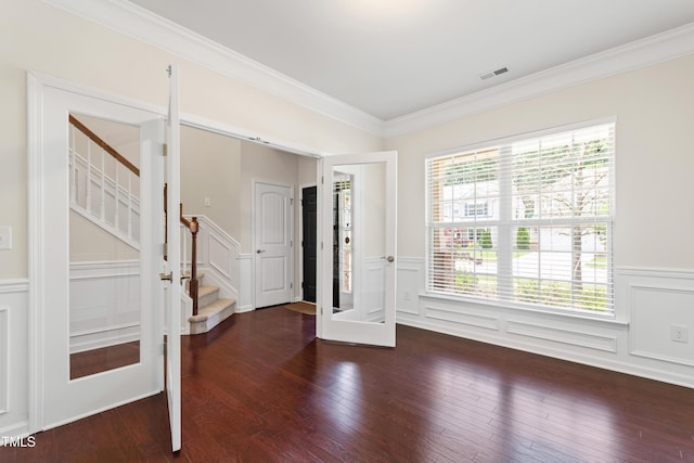 1320 Cozy Oak Ave, Cary, NC 27519 - entryway with a wainscoted wall, ornamental molding, a decorative wall, wood finished floors, and stairs