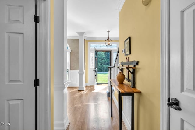 9009 Hometown Dr, Raleigh, NC 27615 - foyer with wood finished floors, ornamental molding, a decorative wall, ornate columns, and wainscoting