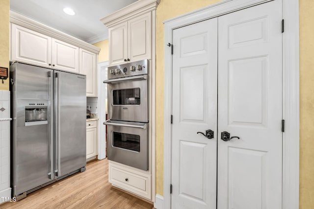 9009 Hometown Dr, Raleigh, NC 27615 - kitchen with stainless steel appliances, light wood-style flooring, and ornamental molding