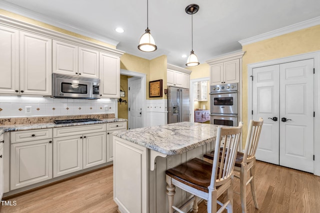 9009 Hometown Dr, Raleigh, NC 27615 - kitchen featuring appliances with stainless steel finishes, light wood finished floors, decorative backsplash, light stone counters, and recessed lighting