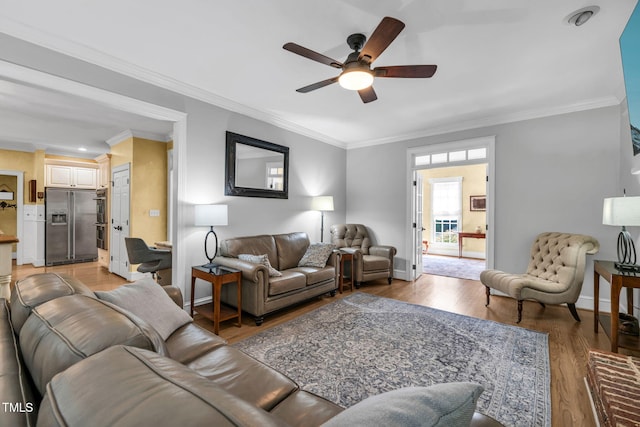 9009 Hometown Dr, Raleigh, NC 27615 - living area featuring a ceiling fan, ornamental molding, and light wood-type flooring