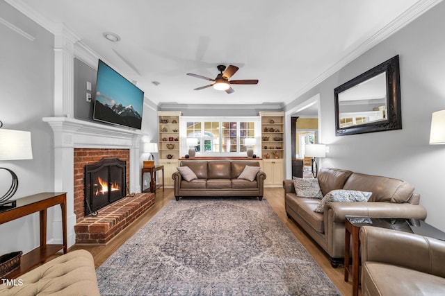 9009 Hometown Dr, Raleigh, NC 27615 - living room with ceiling fan, wood finished floors, ornamental molding, a brick fireplace, and built in features