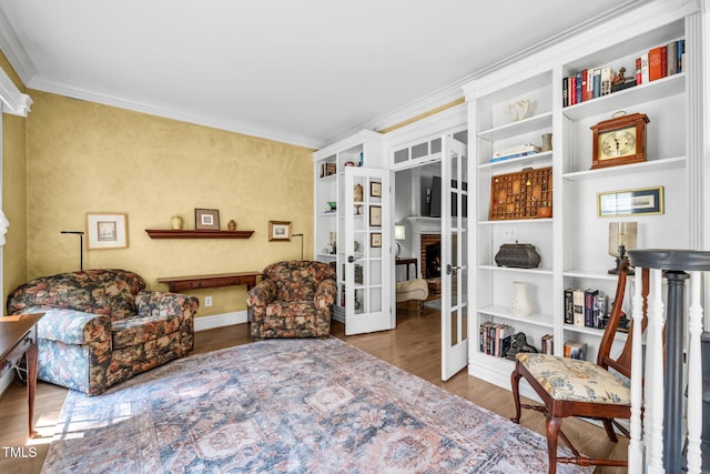 9009 Hometown Dr, Raleigh, NC 27615 - living area featuring french doors, crown molding, wood finished floors, and built in features