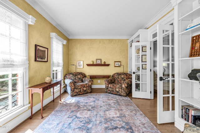 9009 Hometown Dr, Raleigh, NC 27615 - living area with french doors, ornamental molding, and wood finished floors