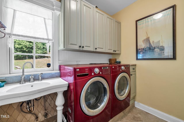 9009 Hometown Dr, Raleigh, NC 27615 - washroom featuring separate washer and dryer, cabinet space, and light tile patterned flooring