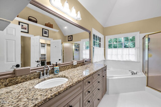 9009 Hometown Dr, Raleigh, NC 27615 - full bathroom with lofted ceiling, vanity, a shower stall, tile patterned floors, and a garden tub