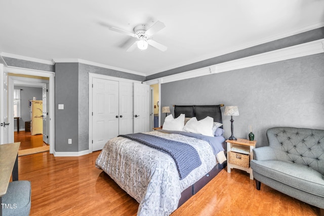 9009 Hometown Dr, Raleigh, NC 27615 - bedroom featuring wood finished floors, crown molding, a closet, and a ceiling fan