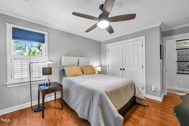 9009 Hometown Dr, Raleigh, NC 27615 - bedroom with wood finished floors, a closet, ornamental molding, and ceiling fan