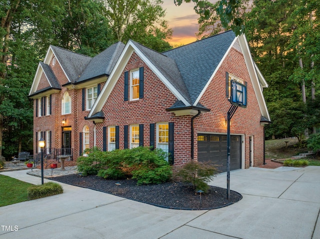 9009 Hometown Dr, Raleigh, NC 27615 - view of front facade featuring concrete driveway, roof with shingles, a garage, and brick siding