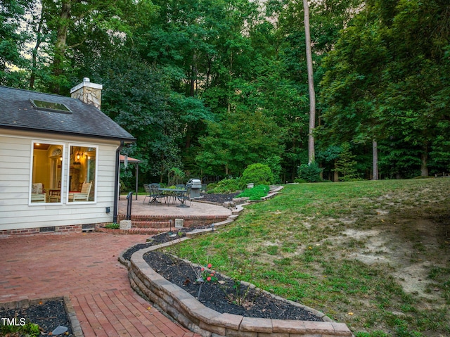 9009 Hometown Dr, Raleigh, NC 27615 - view of grassy yard with a patio area and outdoor dining area