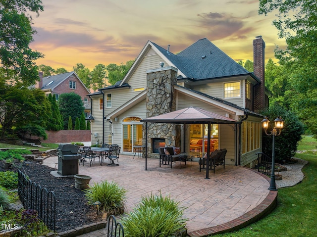 9009 Hometown Dr, Raleigh, NC 27615 - back of house featuring an outdoor hangout area, a patio area, a chimney, a gazebo, and roof with shingles