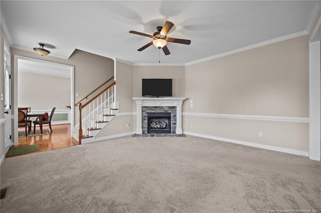 34 Westchester Ln, Angier, NC 27501 - unfurnished living room featuring ornamental molding, carpet floors, a ceiling fan, a fireplace, and stairway