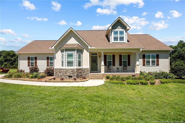 34 Westchester Ln, Angier, NC 27501 - view of front of home with covered porch, board and batten siding, a front yard, and a shingled roof