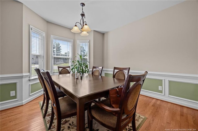 34 Westchester Ln, Angier, NC 27501 - dining room featuring light wood-style floors, wainscoting, and a chandelier