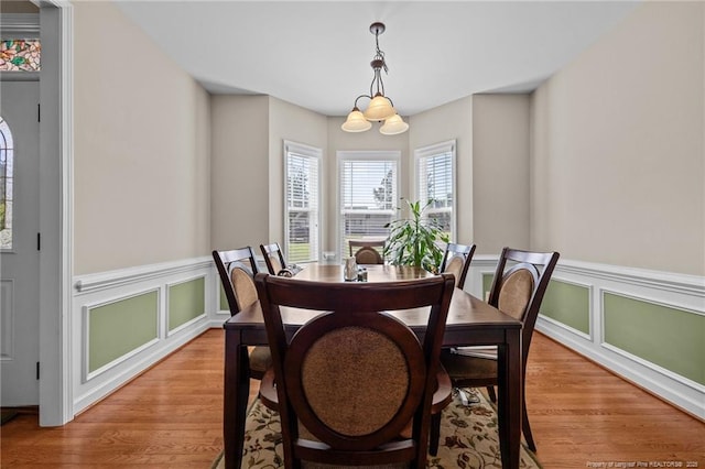 34 Westchester Ln, Angier, NC 27501 - dining space with light wood-type flooring, a wainscoted wall, and a decorative wall