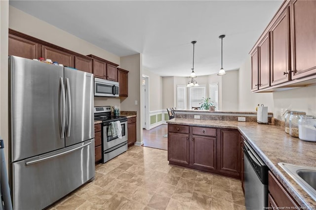 34 Westchester Ln, Angier, NC 27501 - kitchen with stainless steel appliances, a peninsula, pendant lighting, and light countertops