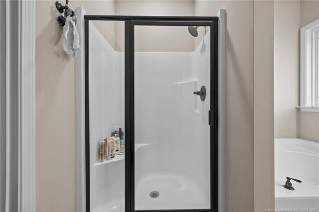 34 Westchester Ln, Angier, NC 27501 - bathroom featuring a stall shower and a garden tub