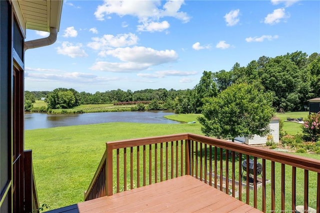 34 Westchester Ln, Angier, NC 27501 - wooden deck with a water view, a lawn, and a storage shed