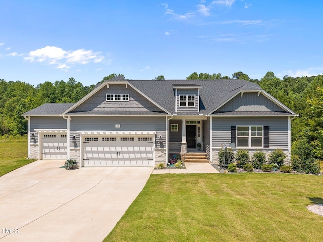 40 Cinnamon Teal Way, Youngsville, NC 27596 - craftsman-style home featuring stone siding, driveway, a garage, and a front lawn