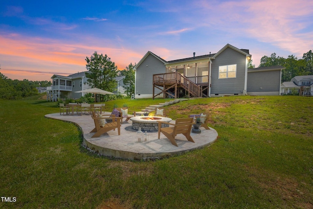 40 Cinnamon Teal Way, Youngsville, NC 27596 - view of green lawn with stairway, a patio, an outdoor fire pit, and a wooden deck