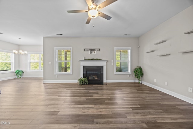 40 Cinnamon Teal Way, Youngsville, NC 27596 - unfurnished living room with wood finished floors, a glass covered fireplace, ceiling fan, and a chandelier