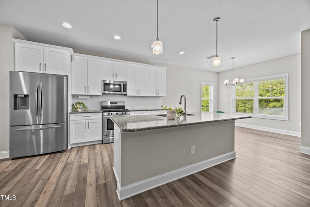 40 Cinnamon Teal Way, Youngsville, NC 27596 - kitchen featuring stainless steel appliances, light wood-type flooring, white cabinets, a chandelier, and recessed lighting