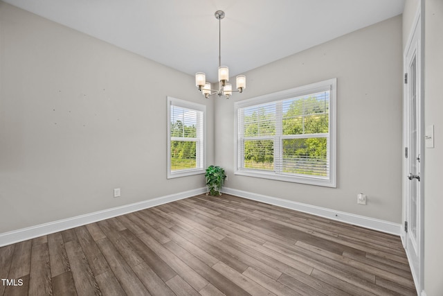 40 Cinnamon Teal Way, Youngsville, NC 27596 - spare room featuring a chandelier and wood finished floors