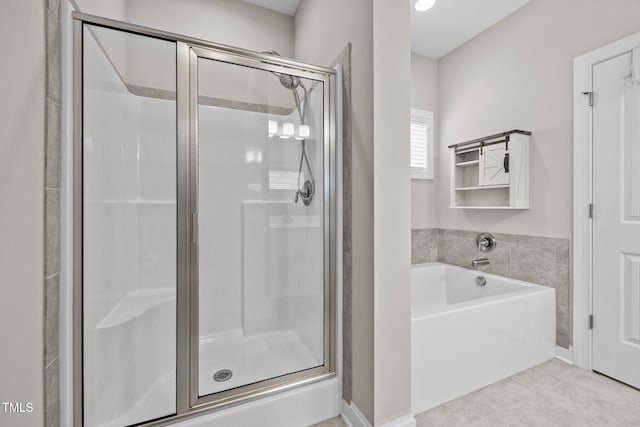 40 Cinnamon Teal Way, Youngsville, NC 27596 - full bath with a shower stall, a garden tub, and tile patterned flooring