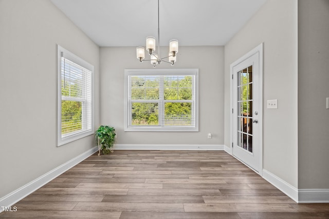 40 Cinnamon Teal Way, Youngsville, NC 27596 - unfurnished dining area featuring a chandelier, healthy amount of natural light, and wood finished floors