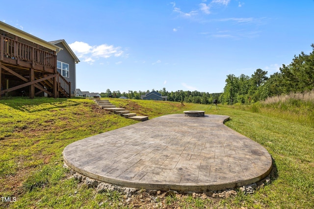 40 Cinnamon Teal Way, Youngsville, NC 27596 - view of grassy yard featuring stairs, a fire pit, a deck, and a patio area