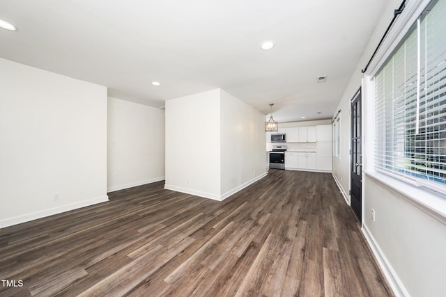 313 13th St, Butner, NC 27509 - unfurnished living room with dark wood-style floors and recessed lighting