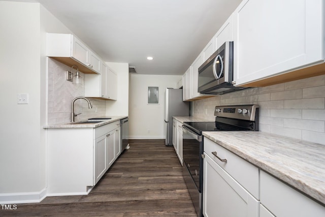 313 13th St, Butner, NC 27509 - kitchen featuring stainless steel appliances, decorative backsplash, white cabinets, and recessed lighting