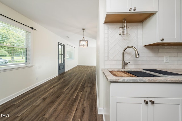 313 13th St, Butner, NC 27509 - kitchen with dark wood-style floors, backsplash, white cabinetry, and light stone counters