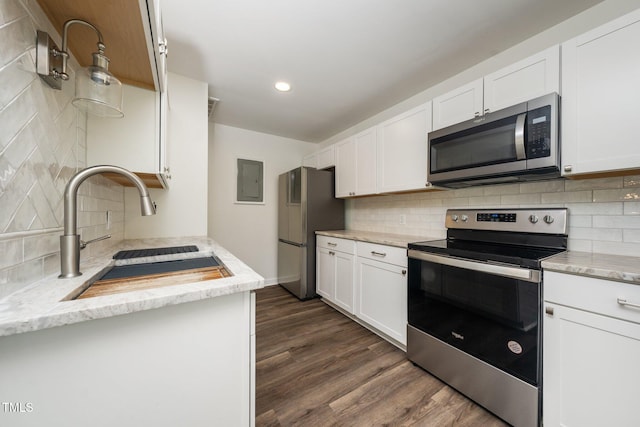 313 13th St, Butner, NC 27509 - kitchen with stainless steel appliances, backsplash, dark wood-style flooring, white cabinets, and recessed lighting