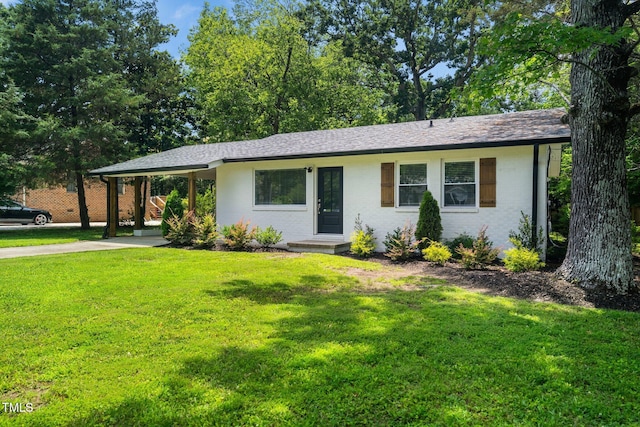 313 13th St, Butner, NC 27509 - ranch-style house featuring an attached carport, driveway, a front lawn, and brick siding